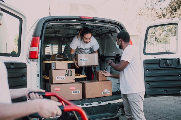 An NGO’s volunteers unloading boxes of food and medicine from a truck