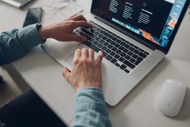 An individual using social service software on a laptop