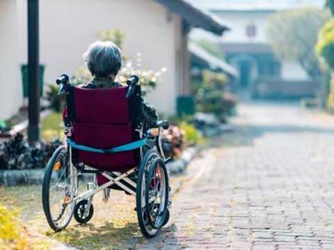 An old-age woman in a wheelchair