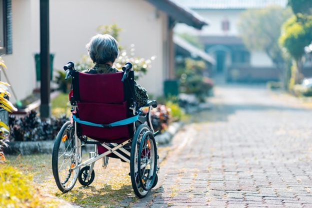 An old-age woman in a wheelchair