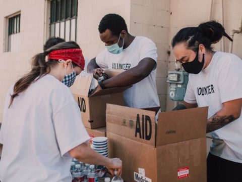 NGO volunteers distributing food and medicines