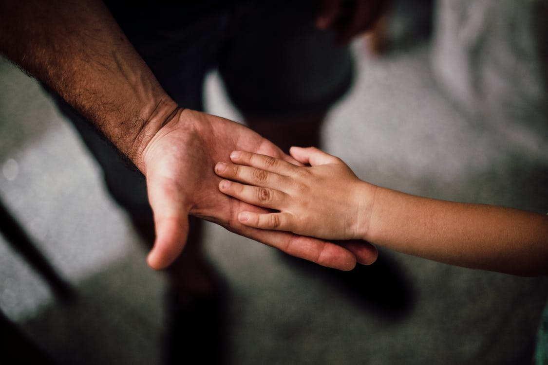 A child’s hand on an adult’s palm