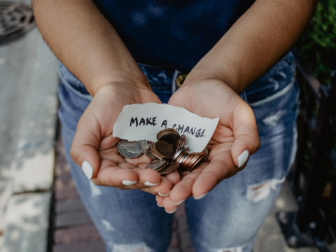 A girl holding coins