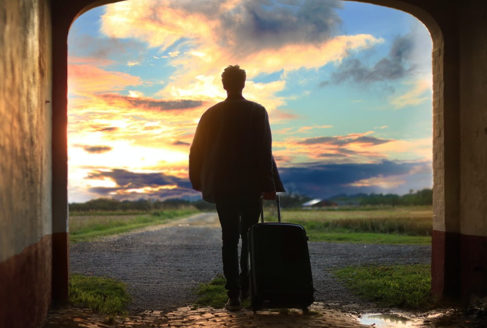 A person holding a luggage