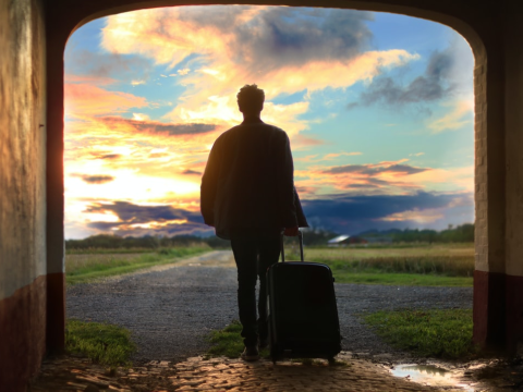 A person holding a luggage