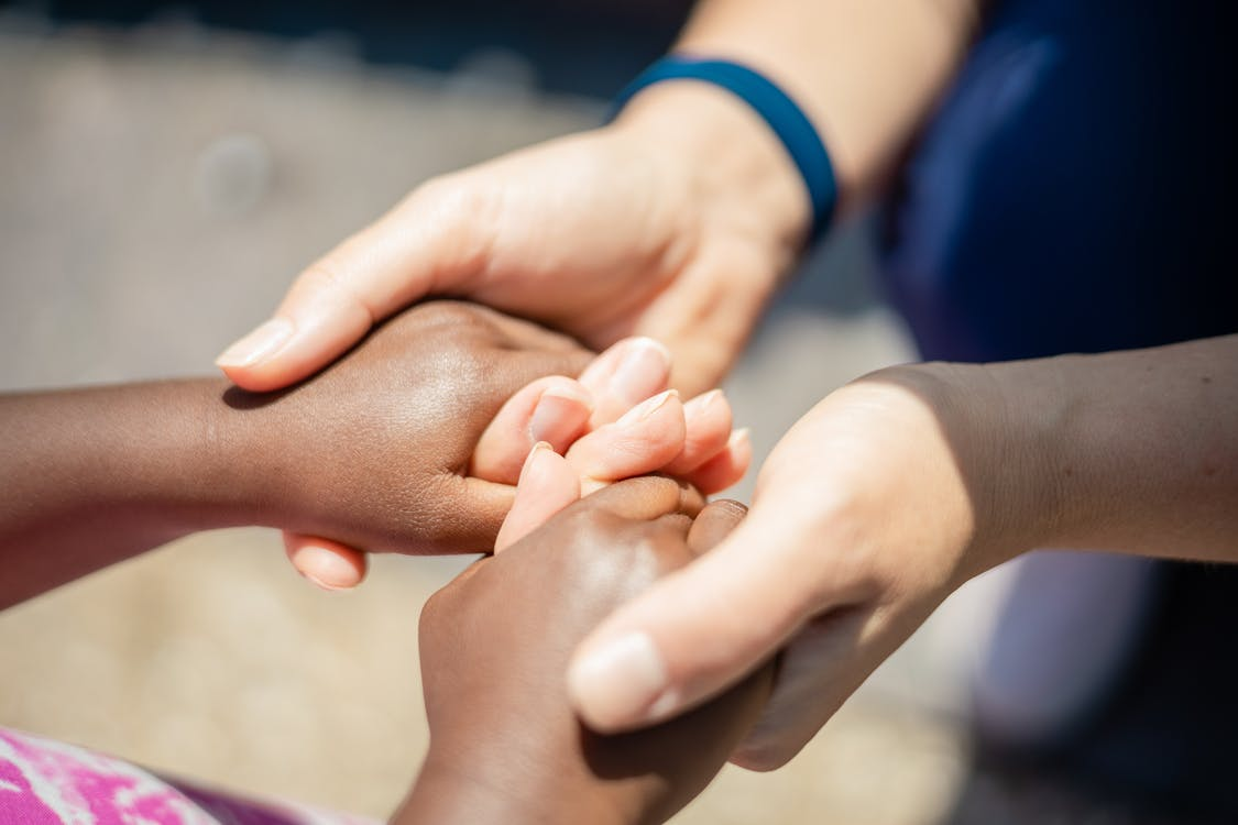 a woman holding a child's hand