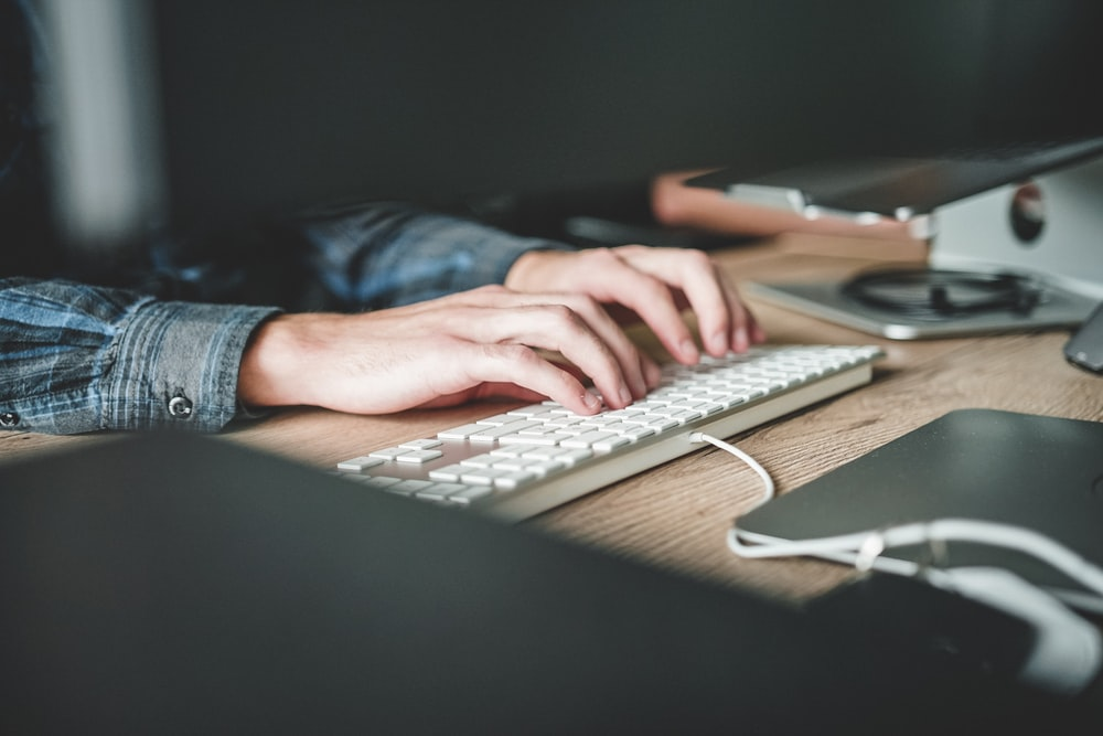 a woman typing on a keyboard